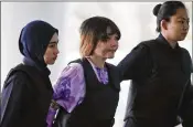  ?? SADIQ ASYRAF / ASSOCIATED PRESS ?? Defendant Doan Thi Huong (center) of Vietnam is escorted by police as she arrives for a court hearing Tuesday at Shah Alam courthouse in Shah Alam, outside Kuala Lumpur, Malaysia.