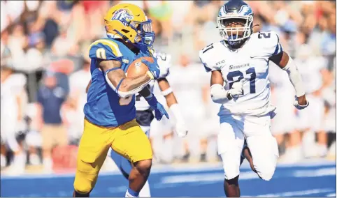  ?? University of New Haven ?? New Haven’s Dev Holmes (0) runs away from Southern Connecticu­t’s Elijah Alexandre (21) on Saturday.