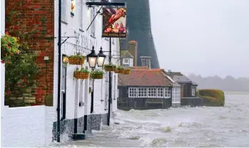  ?? ?? High tide: Sea water laps against a pub in Langstone, near Havant, Hampshire