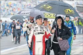  ?? PHOTO/ TERRY RENNA] ?? John Hunter Nemechek, from left, walks down pit road after getting out of his car after rain stopped the NASCAR Daytona 500 auto race at Daytona Internatio­nal Speedway on Sunday. [AP