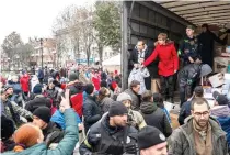  ?? AFP PHOTO ?? RELIEF FOR RESIDENTS
Local residents gather around a vehicle to receive aid in the center of the city of Kherson, southern Ukraine on Friday, Nov. 18, 2022.