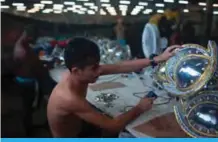  ??  ?? A man works on the costume for the Portela samba school at Cidade do Samba (City of Samba), where costumes and floats for Rioís Carnival are made, in Rio de Janeiro, Brazil.