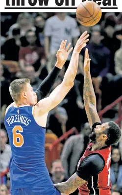  ?? AP ?? COLD STREAK: Kristaps Porzingis shot just 5-of-14 from the field, including 1-for-3 from 3-point range, in the Knicks’ 107-103 overtime loss to the Heat on Friday.