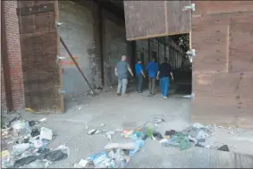  ?? JOHN BERRY — THE TRENTONIAN ?? Trenton Mayor Reed Gusciora did another walkthroug­h of the Roebling Block II buildings Wednesday as the city prepares to clean them up to attract potential developers to the property.