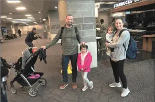  ?? Photo by Ernest A. Brown ?? Don and Michelle Dooley and family arrive at TF Green Airport Tuesday morning.