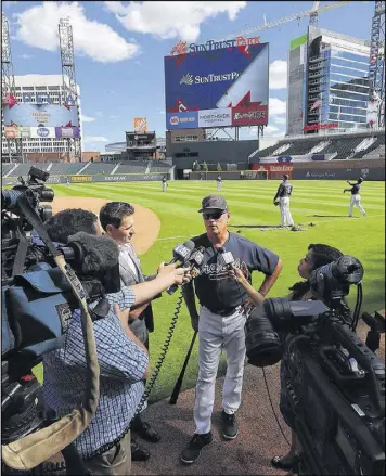  ?? CURTIS COMPTON / CCOMPTON@AJC.COM ?? Manager Brian Snitker meets with the media in the Braves’ new home as they prepare to take on the Yankees in an exhibition.