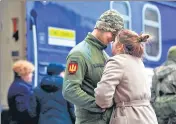  ?? ?? A Ukrainian serviceman says goodbye to his girlfriend before departing in the direction of Kyiv, in the city of Lviv.