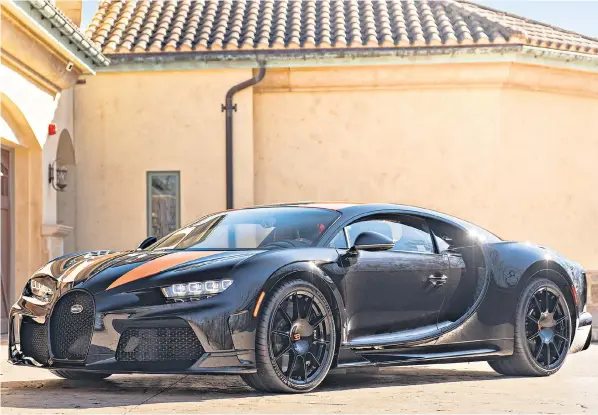  ?? ?? The Bugatti Chiron Super Sport 300+, which once topped 300mph, is up for sale at Bonhams in Arizona for £4.3m. The black and orange road car is one of just 30 examples made and has 255 miles on the clock