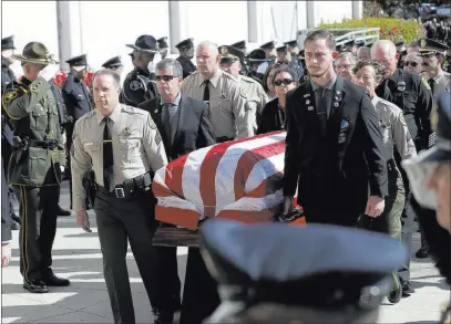  ?? Marcio Jose Sanchez ?? The Associated Press A casket with the body of Ventura County Sheriff ’s Sgt. Ron Helus is carried into Calvary Community Church on Thursday in Westlake Village, Calif. Helus was killed in a Nov. 7 shooting in Thousand Oaks.