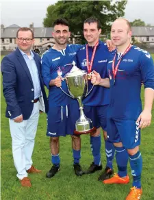  ??  ?? Mario Puchowski, General Manager, Glasshouse hotel with Carbury’s Aaron Murrin, Gary Finan and Barry O’Mahoney, winners of the Cup.