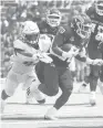  ?? GARY KAZANJIAN/AP ?? Fresno State running back Ronnie Rivers (20) is chased by UConn linebacker Jackson Mitchell, left, during the first half Saturday in Fresno, Calif.