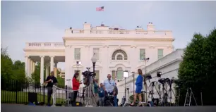  ?? AP ?? Television network crews begin their evening news broadcast from the driveway outside the West Wing of the White House in Washington. —