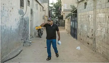  ?? FATIMA SHBAIR/AP ?? Ibrahim Slaieh, a Palestinia­n, drinks coffee on Aug. 21 in the Gaza Strip before crossing the border to work at a grocery store in southern Israel.