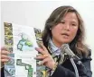  ?? SPECTRUM NEWS ?? Sherry Li presents a brochure for the “China City” project during a town meeting in 2013 in Thompson, N.Y. The plan was to draw Chinese investors to New York.