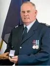  ??  ?? Sergeant Murray Lyons was presented with a medal for 28 years’ service to the police.