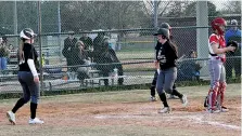  ?? Staff photo by Josh Richert ?? Liberty-Eylau’s Tori Foster scores after teammate Savannah Phelps, left, came home to give the Lady Leopards a 3-0 lead over Paris Chisum on McKenzye Williamson’s (not pictured) two-run double during a pool game in the annual McDonald’s/New Boston...