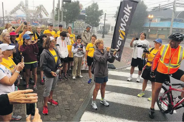  ?? SALLY JENKINS ?? Endurance athlete Diana Nyad rallies her fellow walkers by playing Reveille before the final leg of their journey from Boston to Cape Elizabeth, Maine.