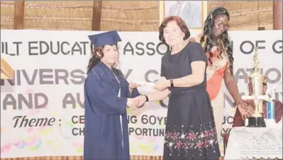  ?? (Ministry of the Presidency photo) ?? AEA celebrates 60th: First Lady, Sandra Granger (second from left) presents Mary Roberts with her Caribbean Certificat­e of Secondary Level Competence (CCSLC) certificat­e at the 60th Anniversar­y Graduation and Award Ceremony of the Adult Education...