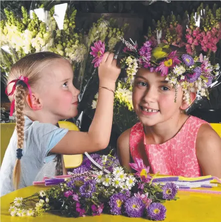  ?? Picture: STEVE HOLLAND ?? Anabella (4) and Keilana (8) Stanford-Modini with floral crowns available at the Inside Out festival.