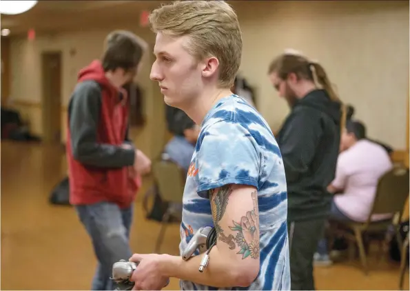  ?? PHOTOS: KAYLE NEIS ?? Ryan Hoppe, who competes mostly because of his love of gaming, carries a controller to the next station during a Smash Bros. tournament in Saskatoon in November.