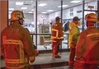  ?? Austin Dave/The Signal ?? Firefighte­rs investigat­e the cause of two people losing consciousn­ess during a HazMat response at a laundry facility on the 22500 block of 14th Street in Newhall Thursday.