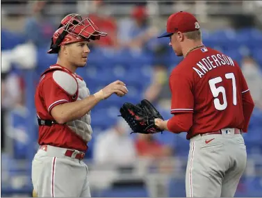  ?? STEVE NESIUS - THE CANADIAN PRESS FOR AP ?? The return of catcher J.T. Realmuto, left, and the addition of starting pitcher Chase Anderson, right, are among the reasons the Phillies enter the 2021 season with high hopes.