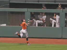  ?? Lea Suzuki / The Chronicle ?? The Giants’ Mauricio Dubón runs down Tyler Heineman’s deep flyball to center field during an intrasquad game at Oracle Park on Wednesday.