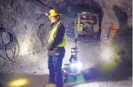  ?? TATIANA FLOWERS/ASSOCIATED PRESS ?? A miner is backed by a robot during a demonstrat­ion in the Edgar Mine near Denver last month.