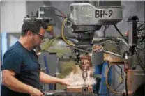  ??  ?? Bob Robinson performs milling work at USSC Group in Lionville, which manufactur­es custom seats for buses, firetrucks and the military.