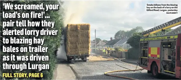  ?? RALPH HEWITT ?? Smoke billows from the blazing hay on the back of a lorry on the Gilford Road, Lurgan, yesterday