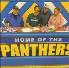  ?? COURTESY PHOTO ?? Gilly Valdez signs his letter of intent to run cross country and track for Eastern New Mexico University.