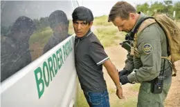  ?? MATT YORK/AP ?? Before being transporte­d, a migrant has his handcuffs removed by a U.S. Border Patrol agent Sept. 8 at the foot of the Baboquivar­i Mountains near Sasabe, Arizona.