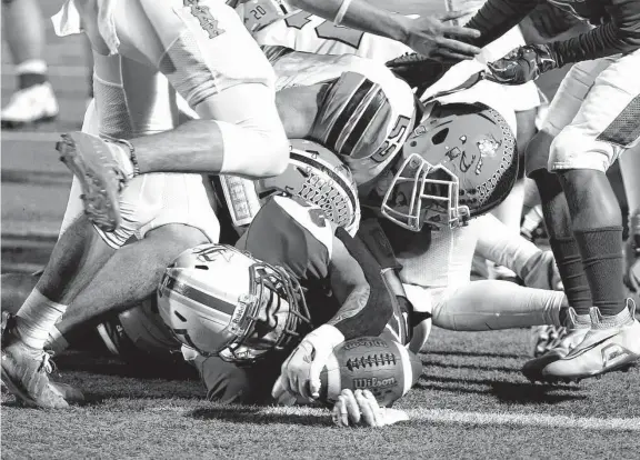  ?? Kin Man Hui/Staff photograph­er ?? Lanier’s Mario Torres extends himself to get a touchdown in the first half to help the Voks take a first-half lead against Burbank during their game Friday night.