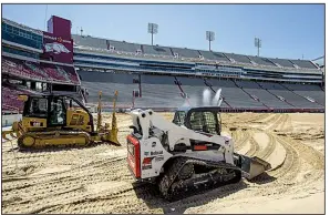  ?? NWA Democrat-Gazette/BEN GOFF ?? Crews work in preparatio­n for grass to be placed on the playing surface at Reynolds Razorback Stadium in Fayettevil­le. The artificial surface was removed in April, and officials say they expect to have real grass in place by early August.