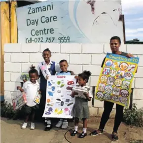  ??  ?? ALL SMILES: Sinebango Cetywayo, left centre, handed over some books to the Zamani Day Care Centre recently. The centre’s deputy principal Isabel Quill is on the far right as Fahima Masum, Acwenga Horner, and Buhle look on