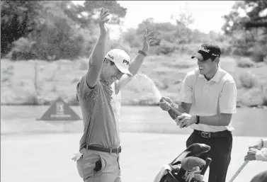  ?? PROVIDED TO CHINA DAILY ?? Charlie Saxon of US gets a champagne shower from his caddie after winning the Guilin Championsh­ip, the fifth event on this year’s PGA Tour Series-China, in Guilin, Guangxi Zhuang autonomous region, on Sunday.