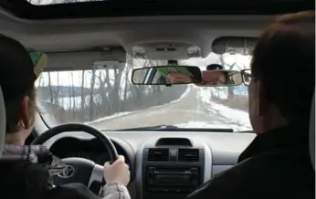  ?? MARK RICHARDSON ?? Andrew Richardson gets some experience driving on an icy gravel road with Young Drivers instructor John Dinnick.