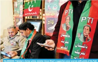  ?? — AFP ?? ISLAMABAD: Pakistan’s former prime minister Imran Khan’s supporters wear scarves with prints of his Pakistan Tehreek-e-Insaf (PTI) party as they listen to a virtual election campaign on phones.