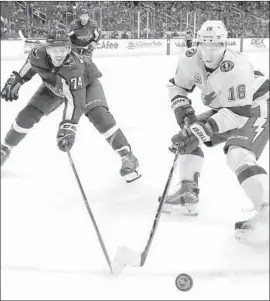  ?? Bruce Bennett Getty Images ?? WASHINGTON’S John Carlson, left, and Tampa Bay’s Ondrej Palat cross sticks as they battle for a loose puck during the third period Tuesday night.