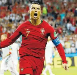  ?? THE ASSOCIATED PRESS ?? Portugal’s Cristiano Ronaldo celebrates after scoring his team’s first goal of a 3-3 draw with Spain on Friday at the World Cup in Sochi, Russia. Ronaldo also scored Portugal’s other two goals to record the sixth hat trick of his internatio­nal career.