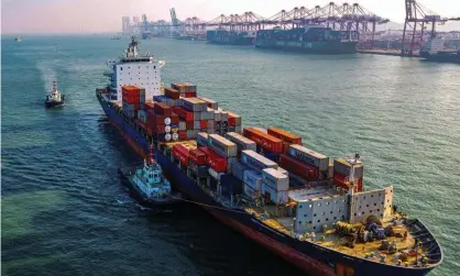  ?? Photograph: STR/AFP via Getty Images ?? A ship laden with containers at Qingdao in China’s eastern Shandong province.