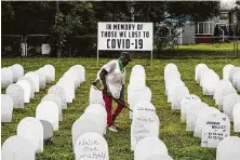  ?? Scott McIntyre / New York Times ?? A makeshift memorial in a Miami park Saturday marks people who have died from COVID-19. Florida and Texas are among states that rolled back restrictio­ns quickly.