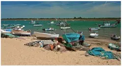  ??  ?? The sands of time: Families from nearby Seville spend holidays here