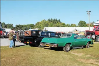  ?? LAUREN HALLIGAN — MEDIANEWS GROUP FILE ?? Attendees admire trucks on display at the 27th annual American Truck Historical Society Hudson Mohawk Chapter Antique Truck & Tractor Show at the Saratoga County Fairground­s in Ballston Spa.