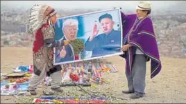  ?? AP ?? Shamans holding posters of US President Donald Trump and North Korean leader Kim Jong perform a ceremony in Lima, Peru, for peace between the two countries.