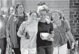  ?? Christophe­r Furlong / Getty Images ?? Concertgoe­rs leave the arena after the explosion. The crowd was filled with young fans of Ariana Grande, an American pop star who was not hurt.