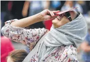  ?? Michael Ciaglo / Houston Chronicle ?? Rabia Safdar smiles outside the Houston Museum of Natural Science, where hundreds gathered.