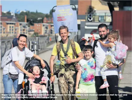  ??  ?? Major Chris Brannigan walking barefoot to raise money for his daughters rare medical condition met by Gail and Matthew Rich with kids Louis, Jessica and Nicole