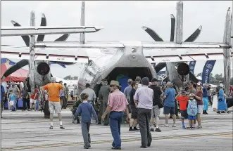  ?? TY GREENLEES / STAFF ?? The unusual shape of the Navy C-2 Greyhound frames spectators on Saturday at the 44th Vectren Dayton Air Show.