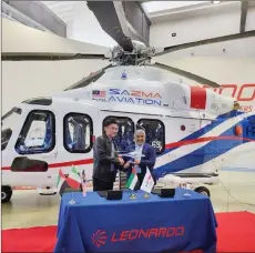  ?? ?? Chua (left) taking delivery of the third Leonardo AW139 helicopter from Mohamad Ibrahim Al Mazrouei, general manager of Abu Dhabi Aviation, in Italy recently. The helicopter is used to carry out offshore crew change operations in Sabah waters.